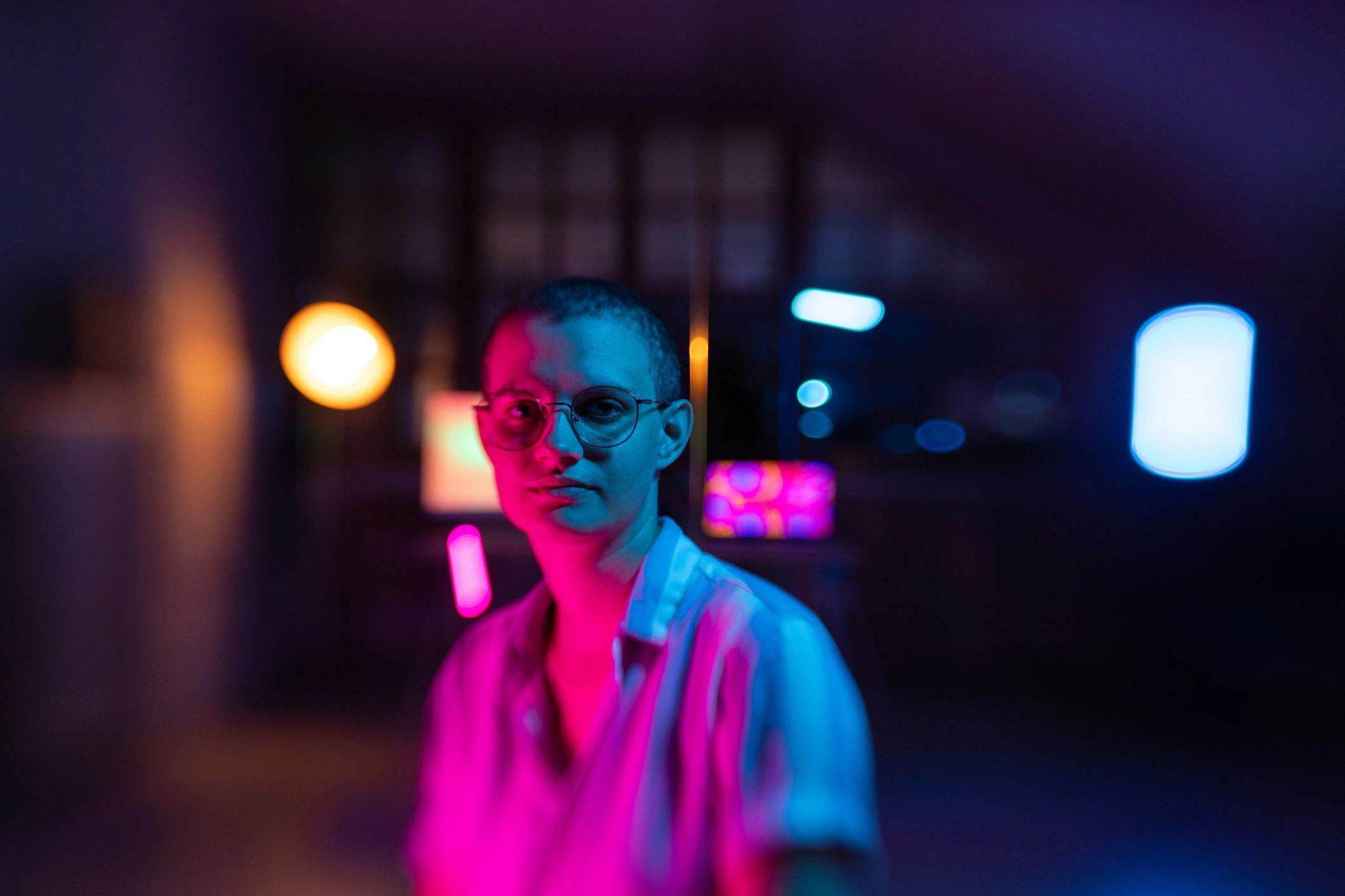 Portrait of a woman lit by vibrant colored lights