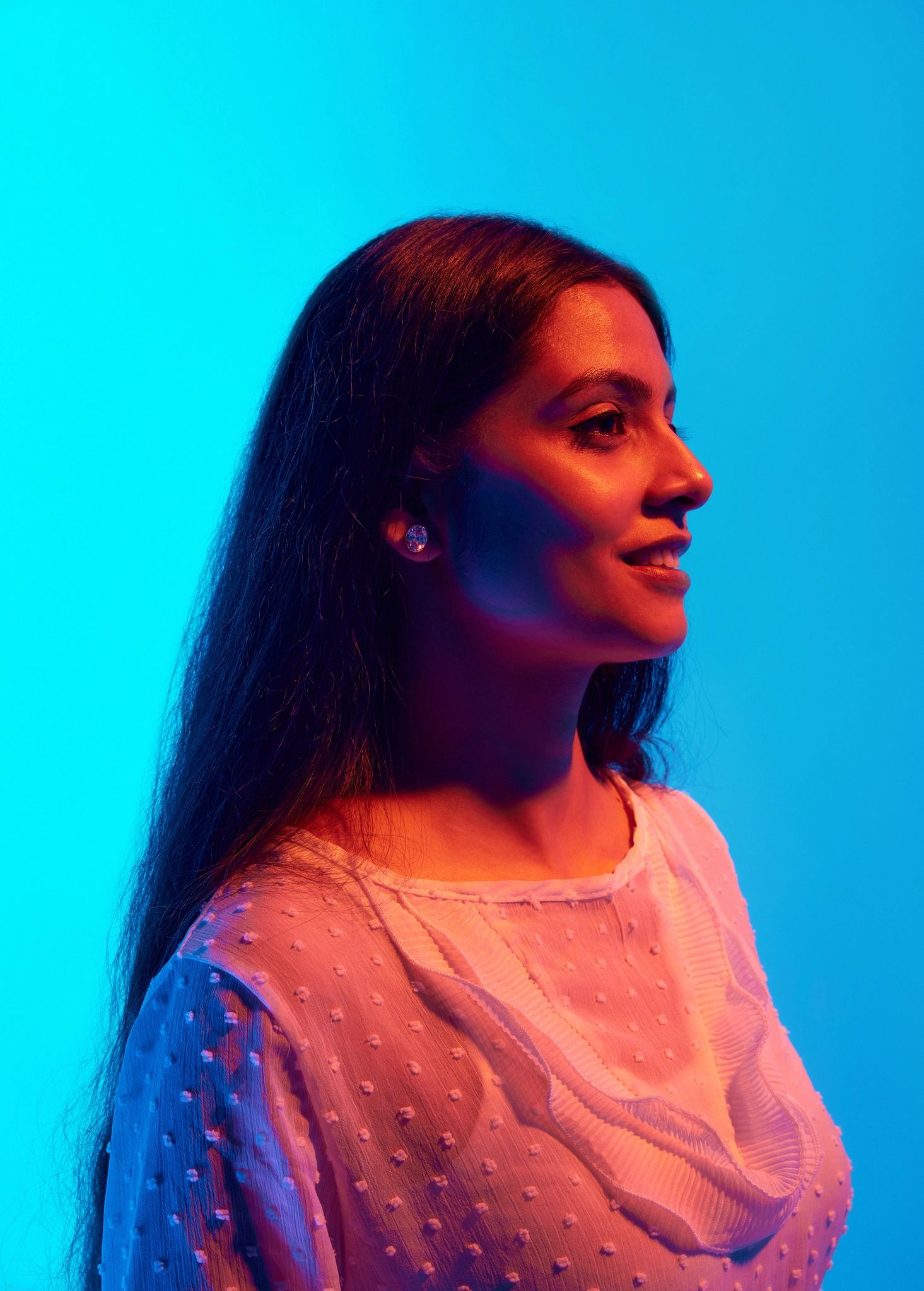 Cinematic portrait of a woman in neon light looking away