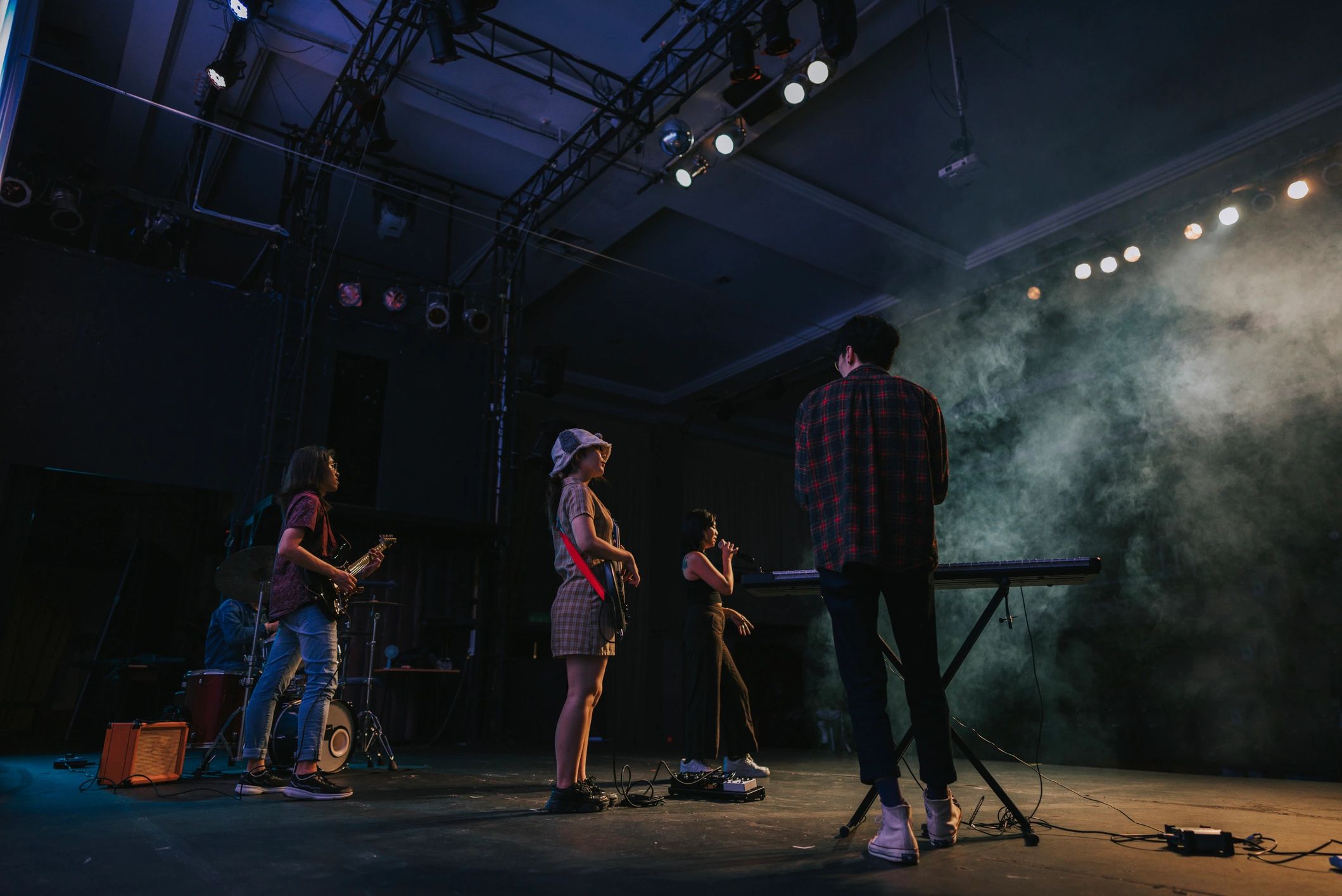Live music performance on stage with dramatic lighting
